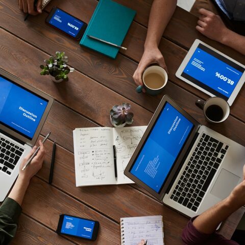 photo of people sitting near wooden table 3183190